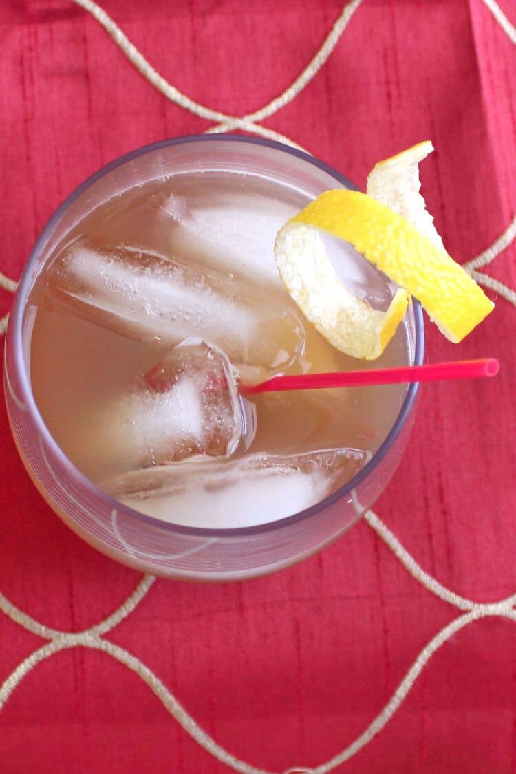 Overhead view of Amaretto Sour cocktail with lemon twist