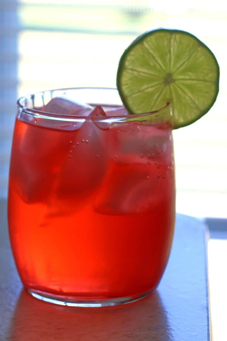 Amber Haze drink in rocks glass with ice backlit by window