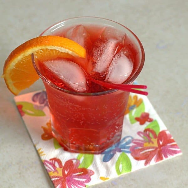 Closeup view of Americano Cocktail with orange slice and red straws