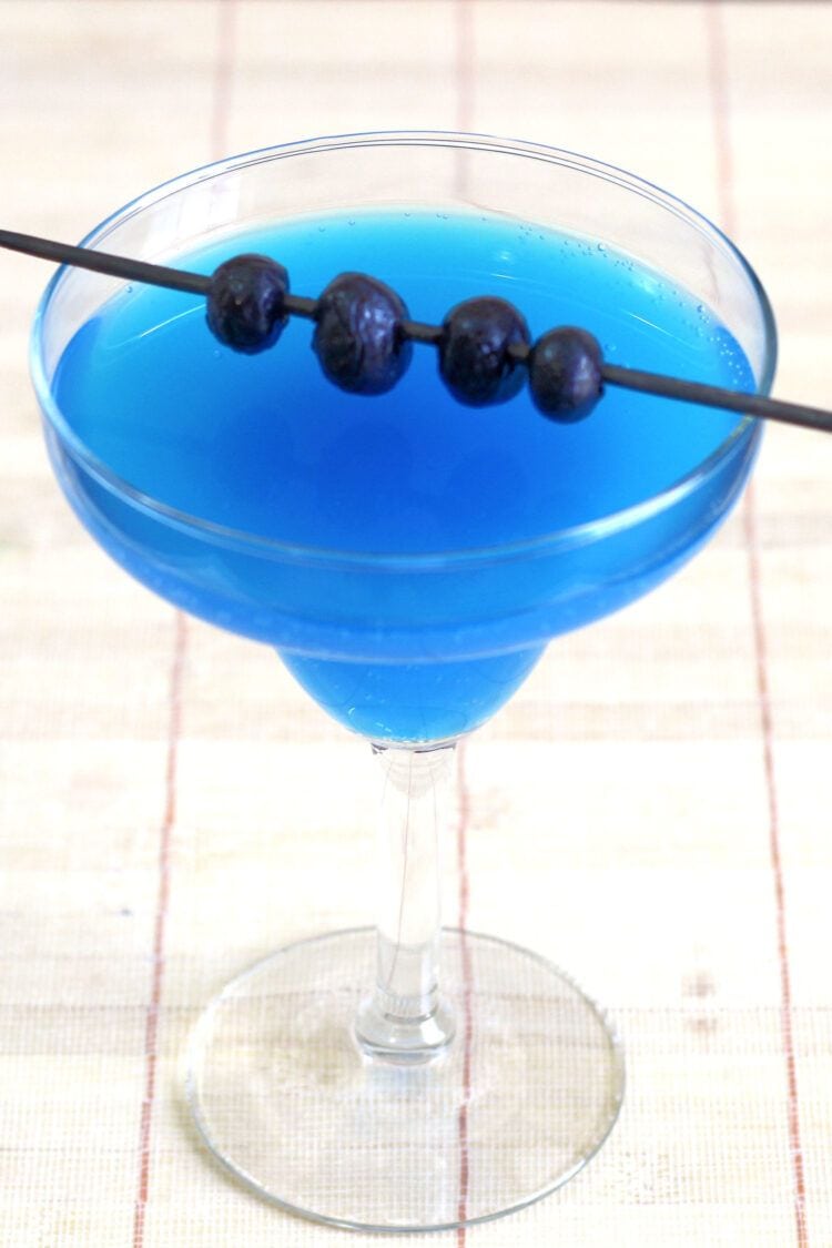 Bright blue Avartini Cocktail with blueberries
