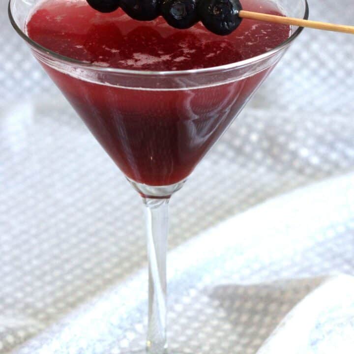 Berry Fusion Martini with blueberries on cocktail pick