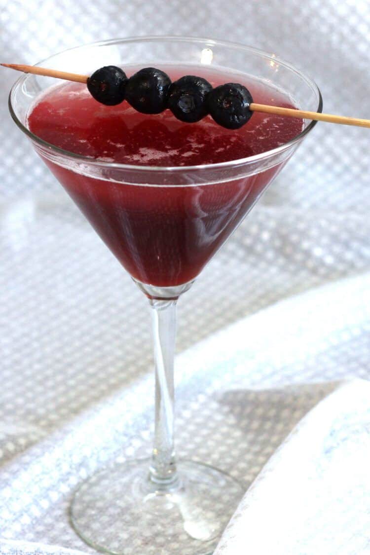 Berry Fusion Martini with blueberries on cocktail pick