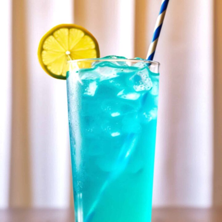 Blue Long Island Iced Tea sitting on coaster on bar