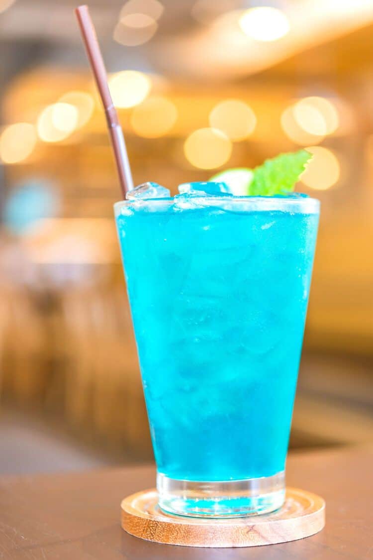 Blue Long Island Iced Tea sitting on coaster on bar