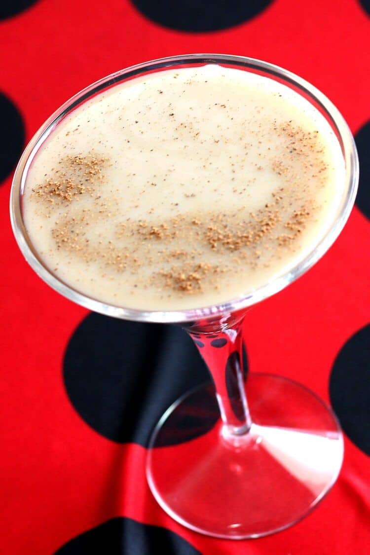 Tilted angle view of Brandy Alexander drink in martini glass with nutmeg sprinkled overtop