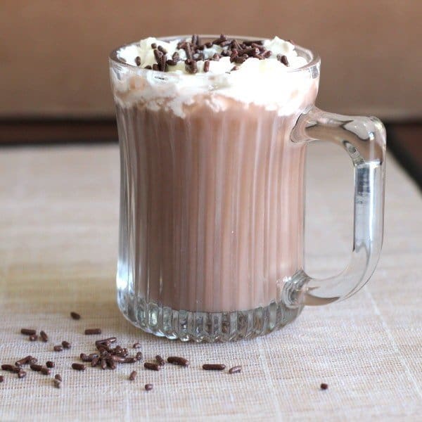 Side view of Cafe Nelson drink with whipped cream and chocolate sprinkles