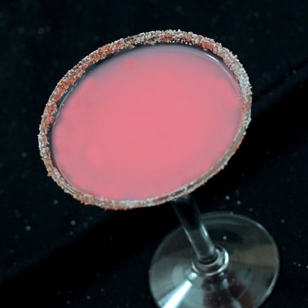 Tilted angle view of Candy Cane Cocktail with candy cane rim