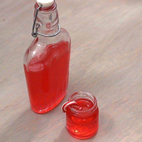 Overhead view of Candy Cane Vodka in shot glass and flask