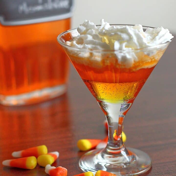 Candy Corn Moonshine in a glass with whipped cream