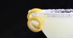 Closeup of yellow drink with lemon garnish