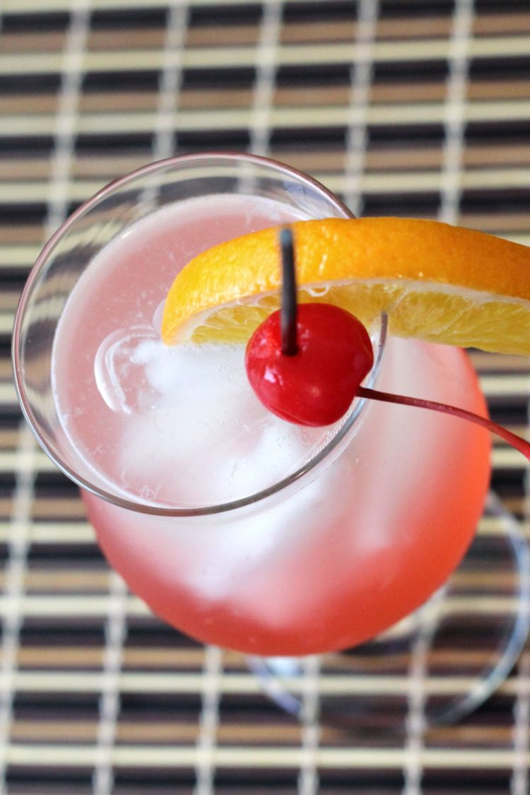 Overhead view of Cherry Vodka Sour drink with orange and cherry