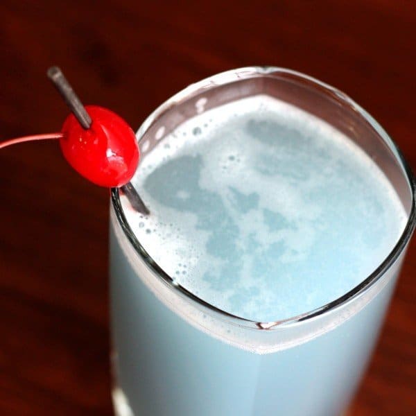 Overhead view of China Blue drink in tall glass with cherry