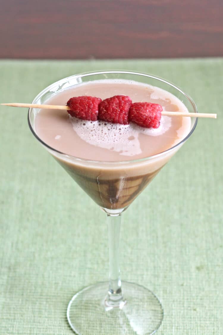 Chocolate Raspberry Martini with chocolate drizzle in glass and raspberry garnish