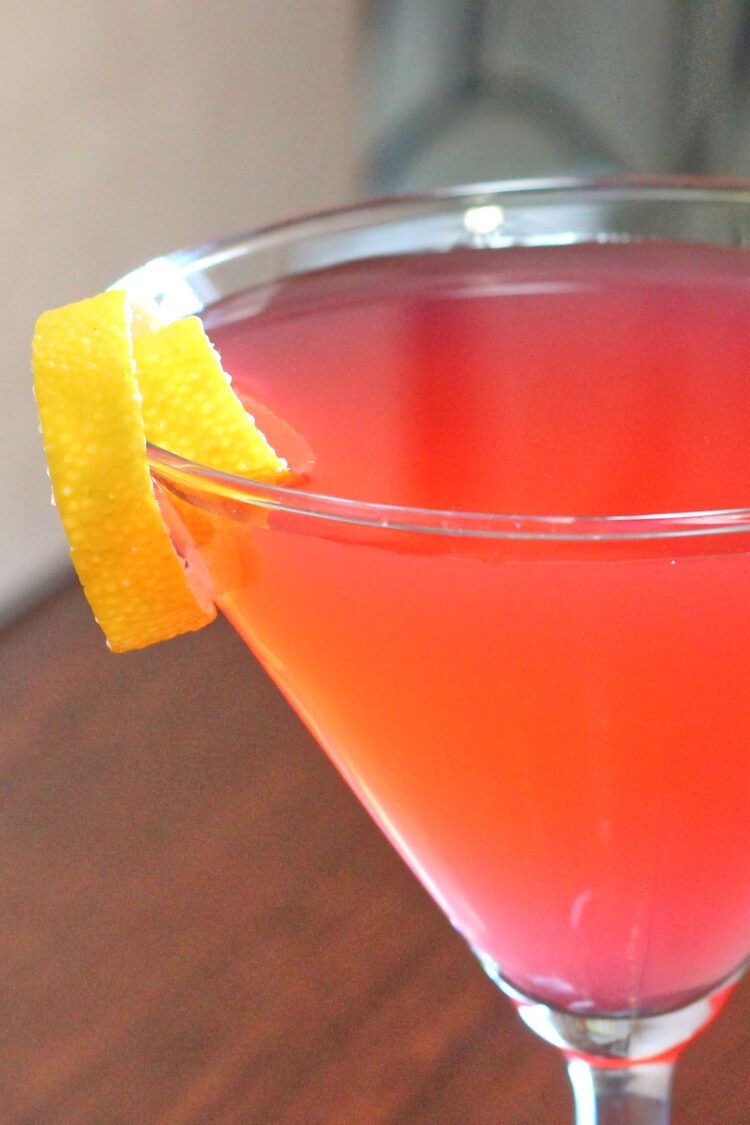 Closeup of Cosmopolitan cocktail with lemon twist