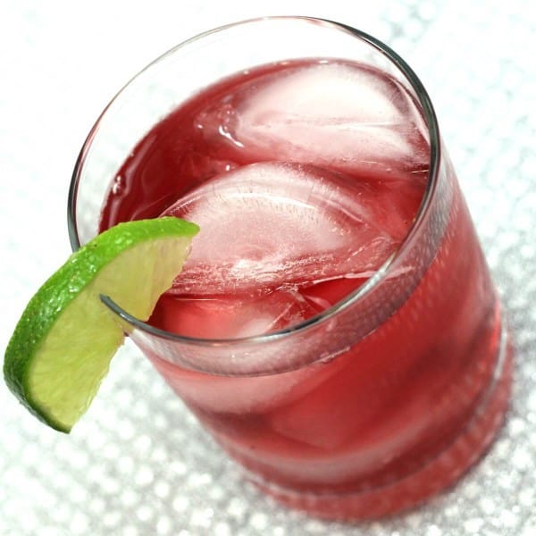 Tilted angle view of Cranberry Gin cocktail with lime wedge