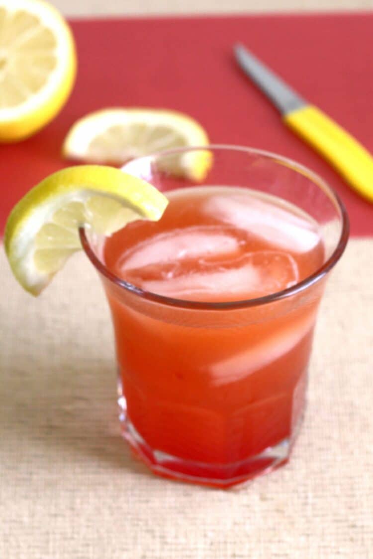 Crystal Cranberry drink with lemons on cutting board
