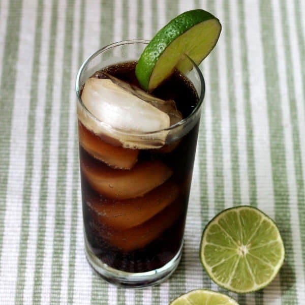 Overhead view of Cuba Libre drink with limes