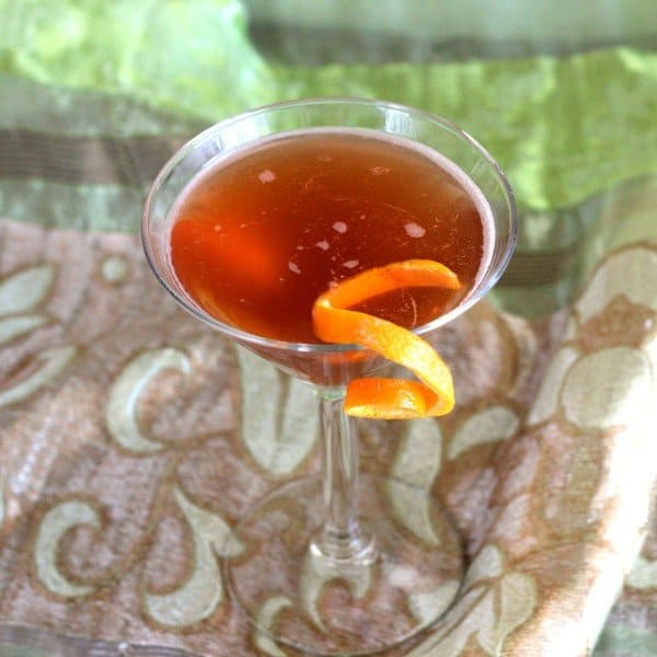 East India Cocktail with orange twist on silky fabric