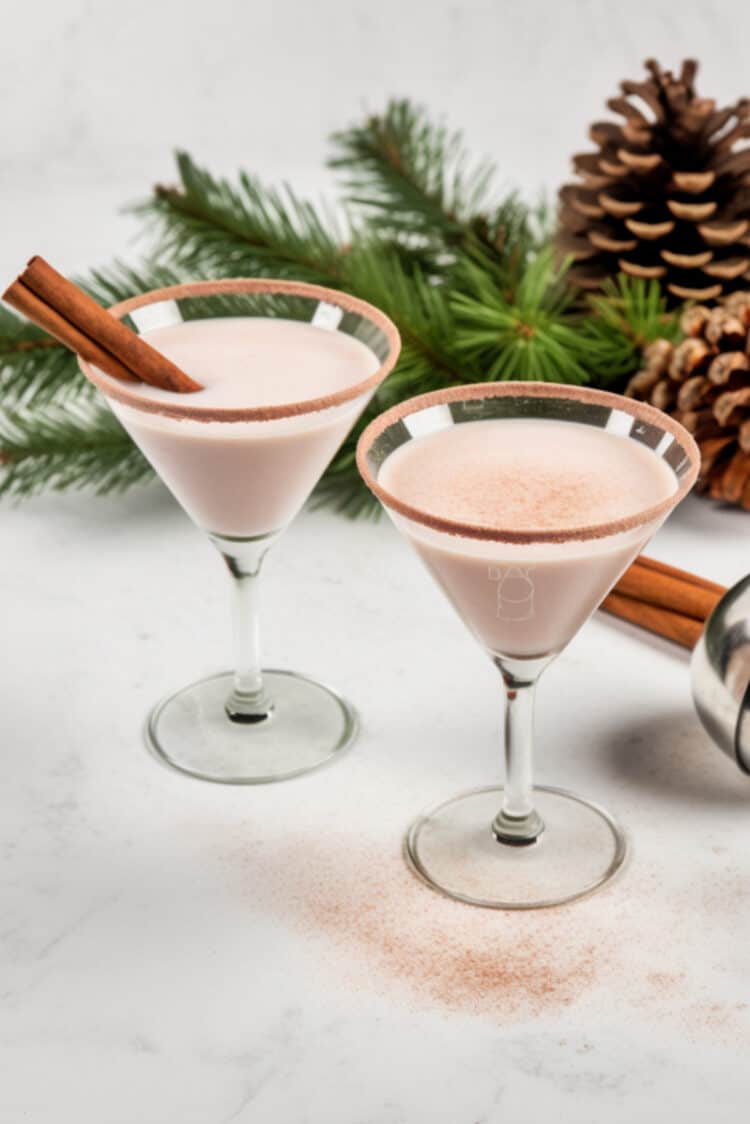 Eggnog Martini surrounded by Christmas decorations