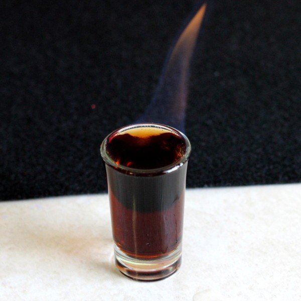 Angled view of Eliminator drink with flame from top