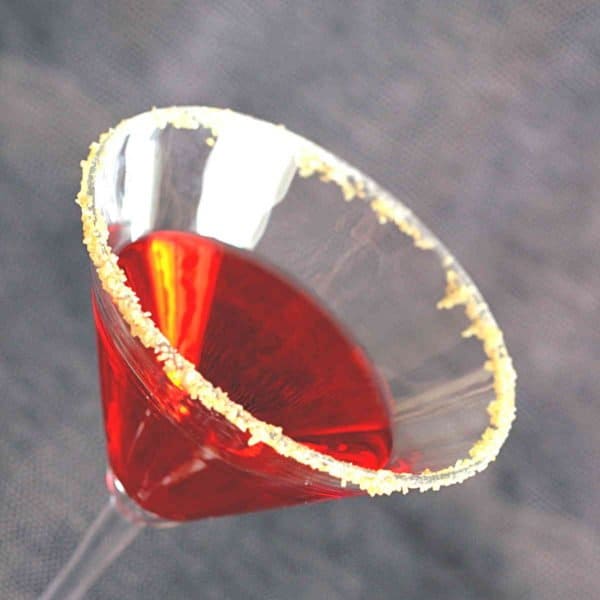 Tilted view of English Rose drink with turbinado sugar rim