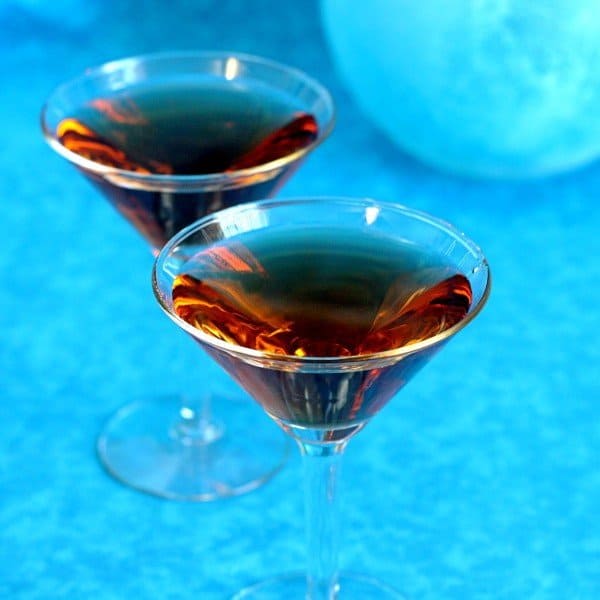 Angled view of Ethel Duffy cocktails against blue background