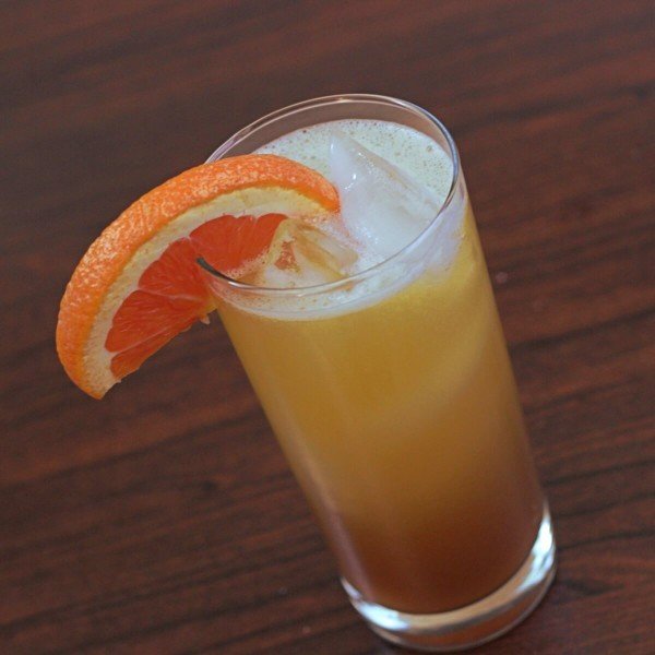 Tilted angle view of Executive Sunrise cocktail in tall glass