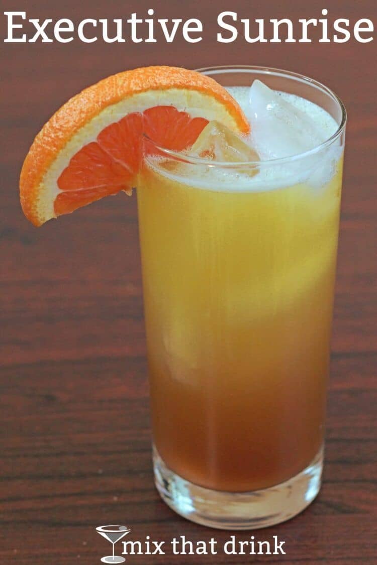 Executive Sunrise cocktail in tall glass with ice and orange slice