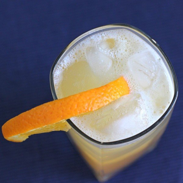 Overhead view of Fat Charley drink in tall glass with orange slice
