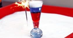 Fourth of July layered cocktail with sparkler