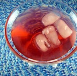 Fuzzyberry drink with ice in cocktail glass