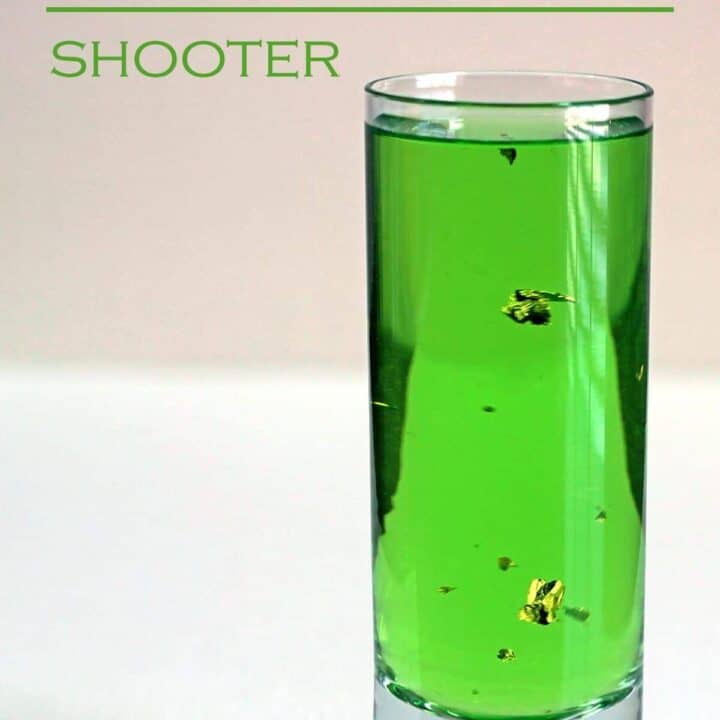 Gold Emerald Shooter drink with gold flecks floating