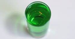 Gold Emerald Shooter drink with gold flecks floating