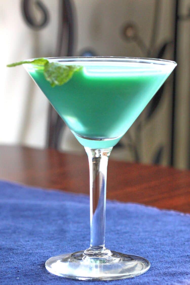 Grasshopper drink with mint sprig on blue cloth