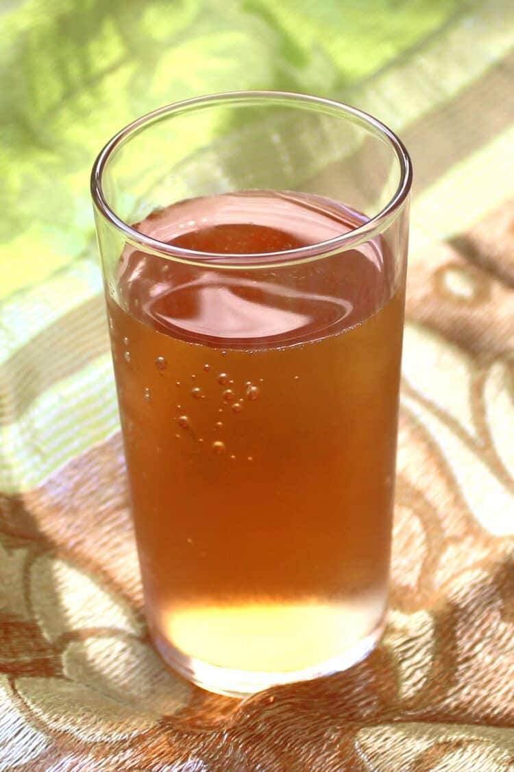 Golden brown cocktail against green cloth background