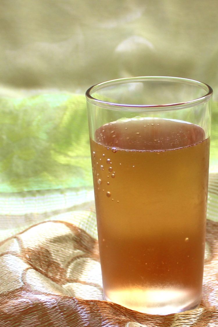 Golden brown cocktail against green cloth background