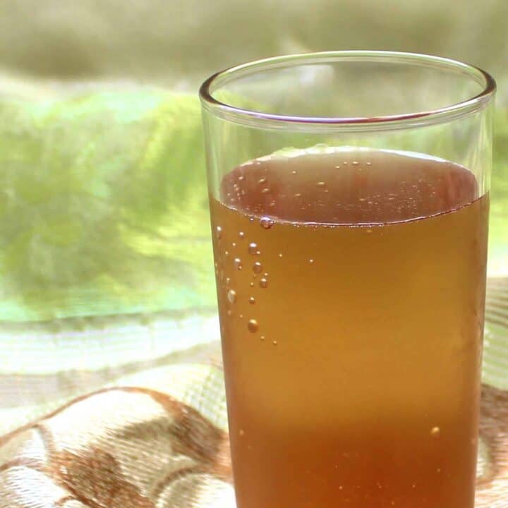 Golden brown cocktail against green cloth background