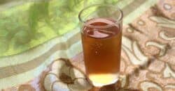 Golden brown cocktail against green cloth background