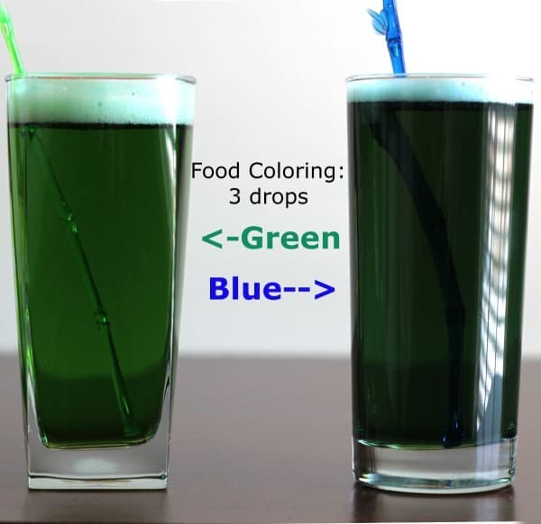Two glasses of pretty green beer, each with three drops of green or blue food coloring