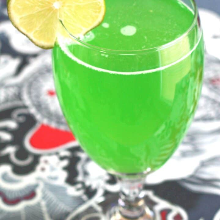 Green Demon drink with lime wheel garnish