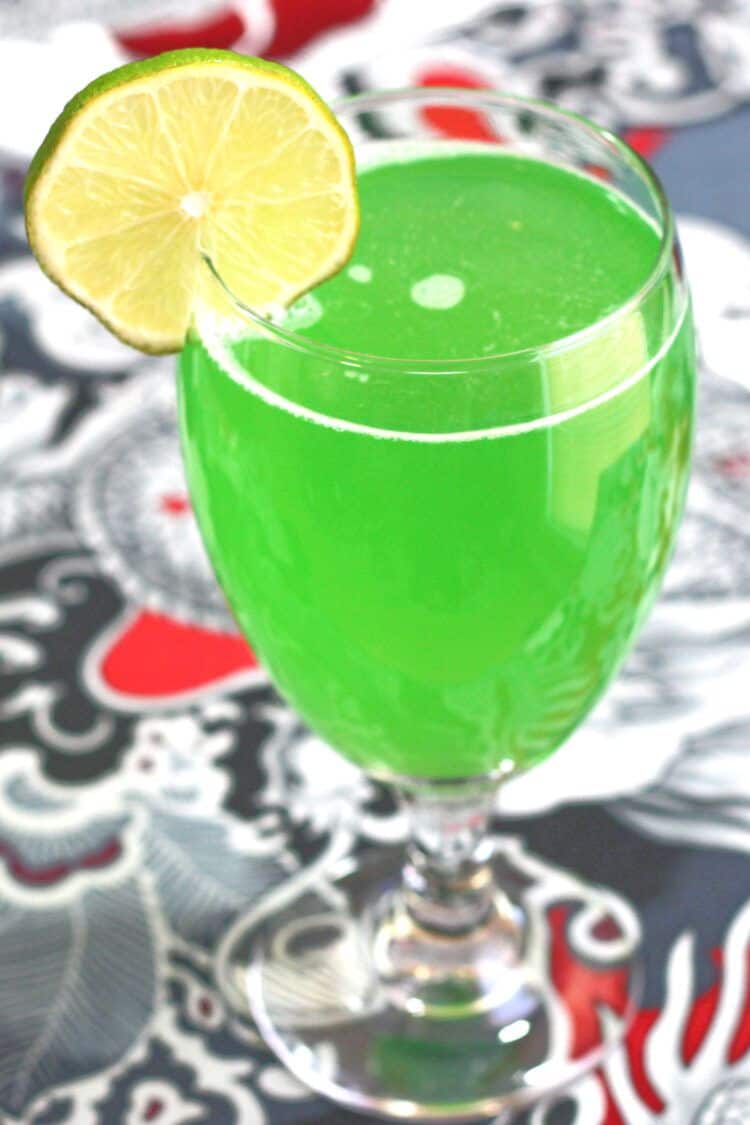 Green Demon drink with lime wheel garnish