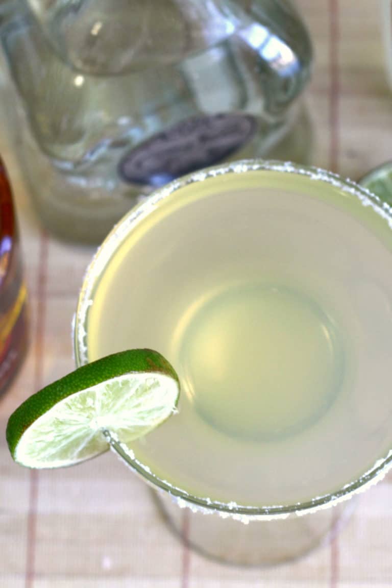 Overhead view of Honey Vanilla Margarita in front of liquor bottles