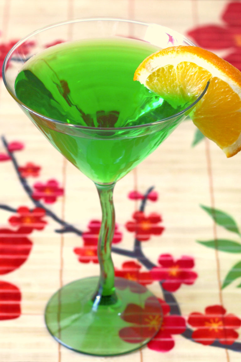 Angled view of green drink with orange slice