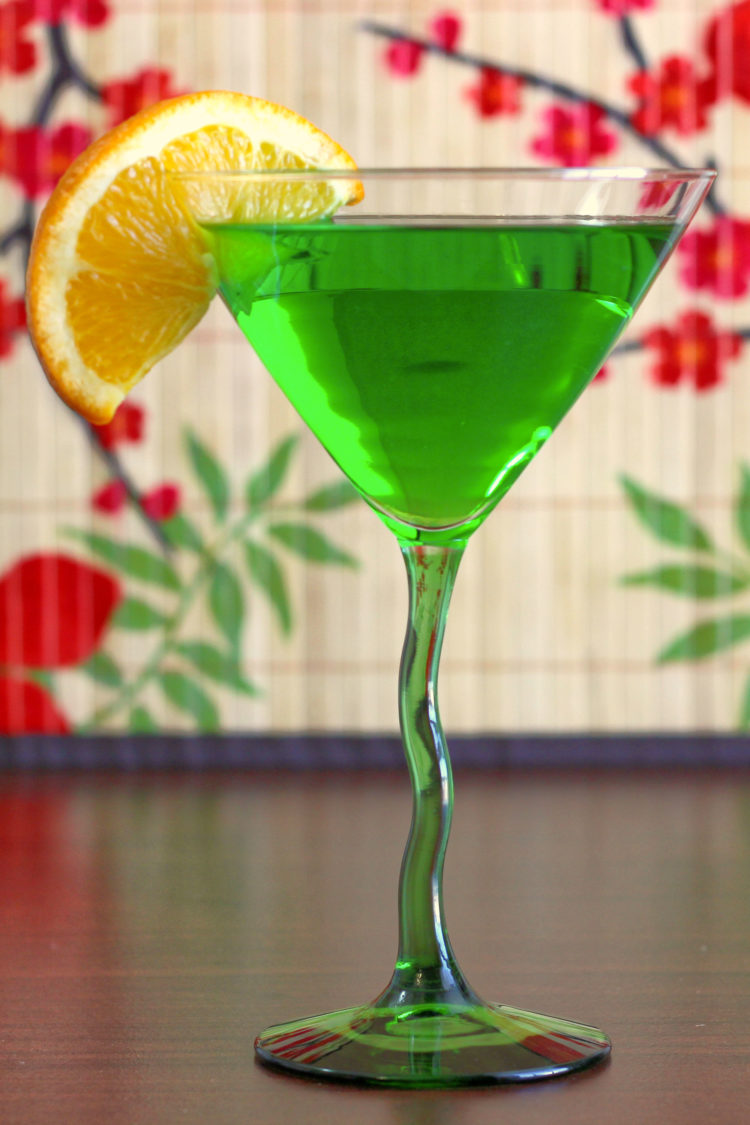 Side view of green drink with orange slice