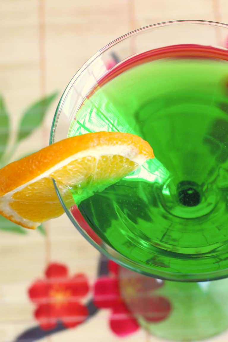 Overhead view of green drink with orange slice