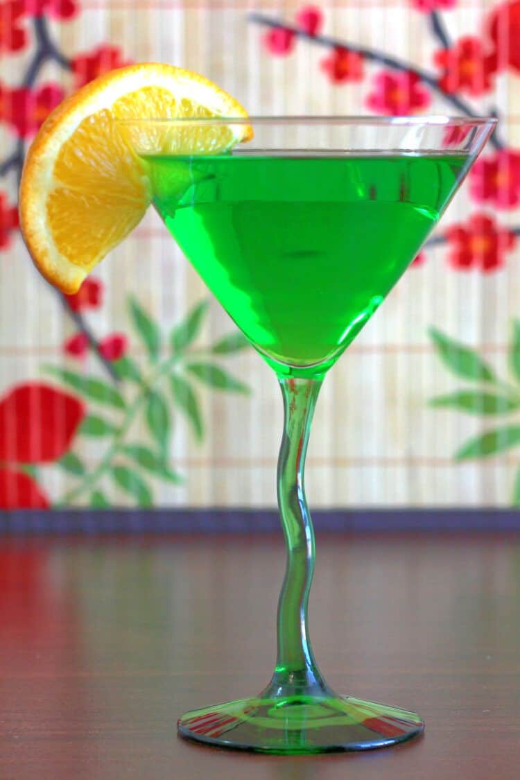 Honeydew Martini garnished with orange slice