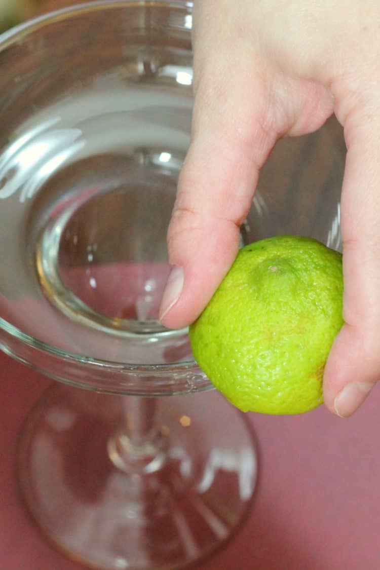 Rubbing lime along rim of glass