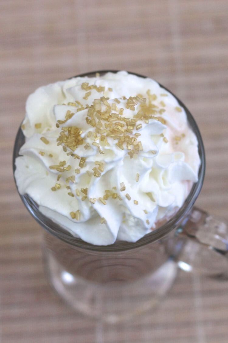 Overhead closeup of whipped cream and sprinkles on top of Irish Coffee drink