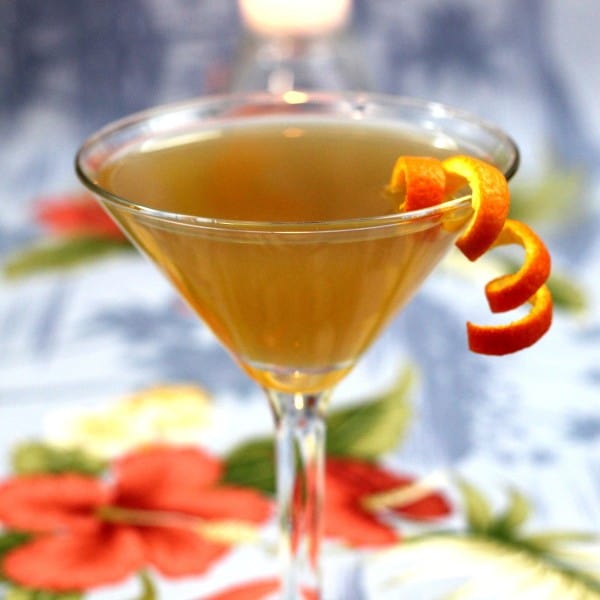 Closeup view of Jamaica Glow drink with orange twist