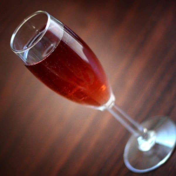 Kir Royale cocktail on wooden bar top
